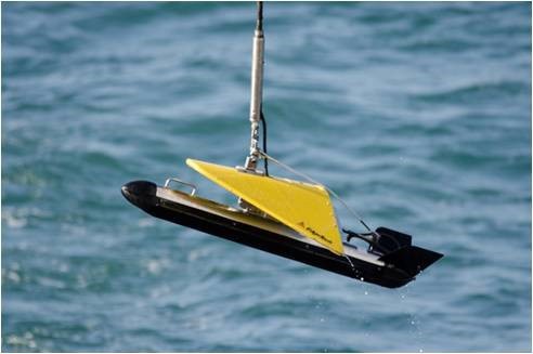 Photograph of side-scan sonar towfish being recovered.