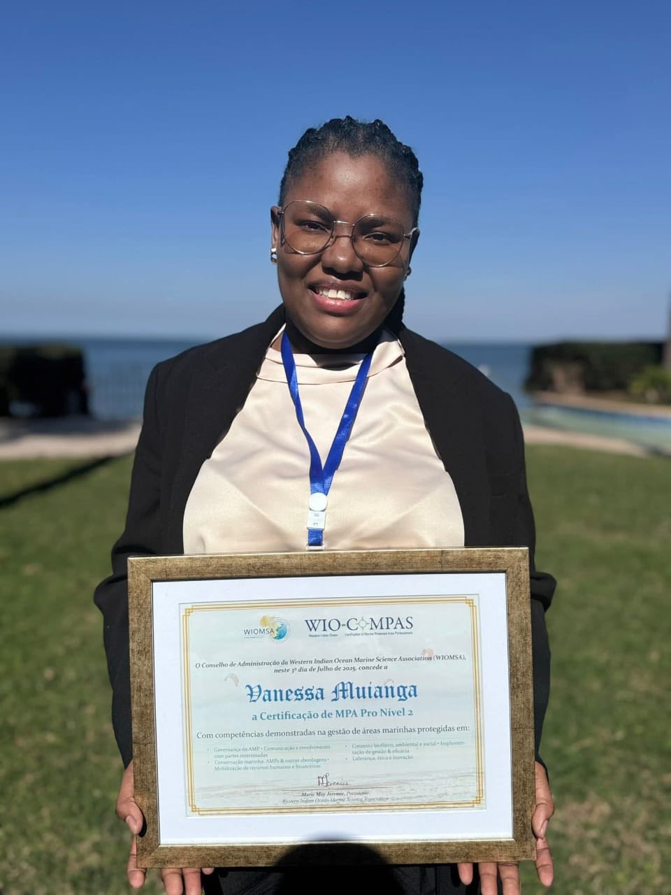 Image of woman holding her MPA accreditation certificate