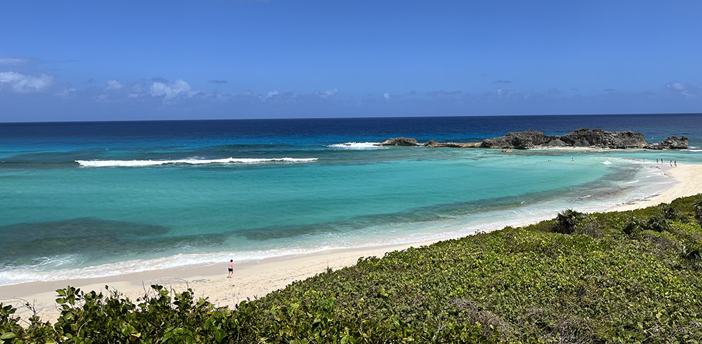 Photograph of a view of a sandy bay with turquoise sea waters on the Turks and Caicos Islands