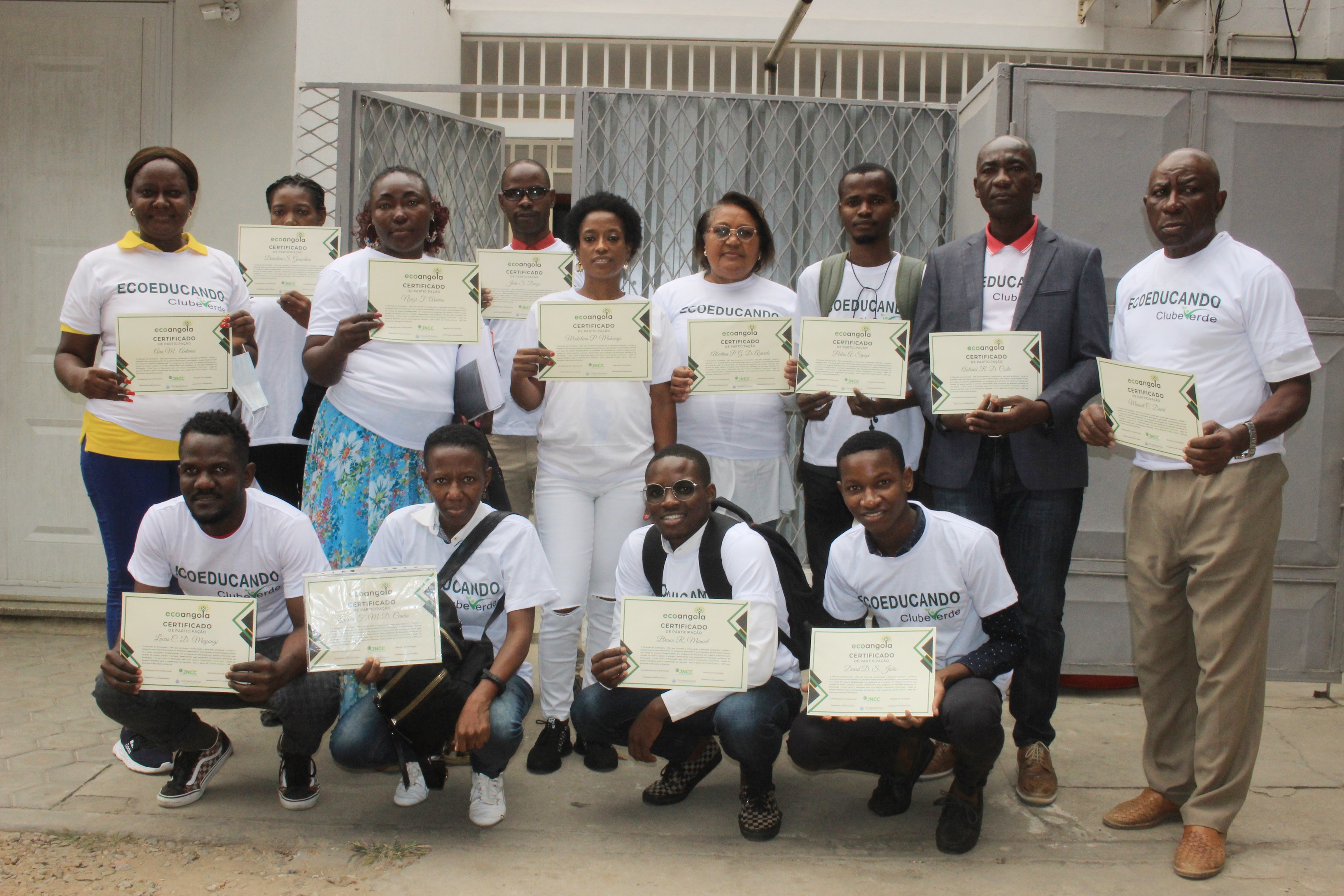 Group of people each holding a certificate