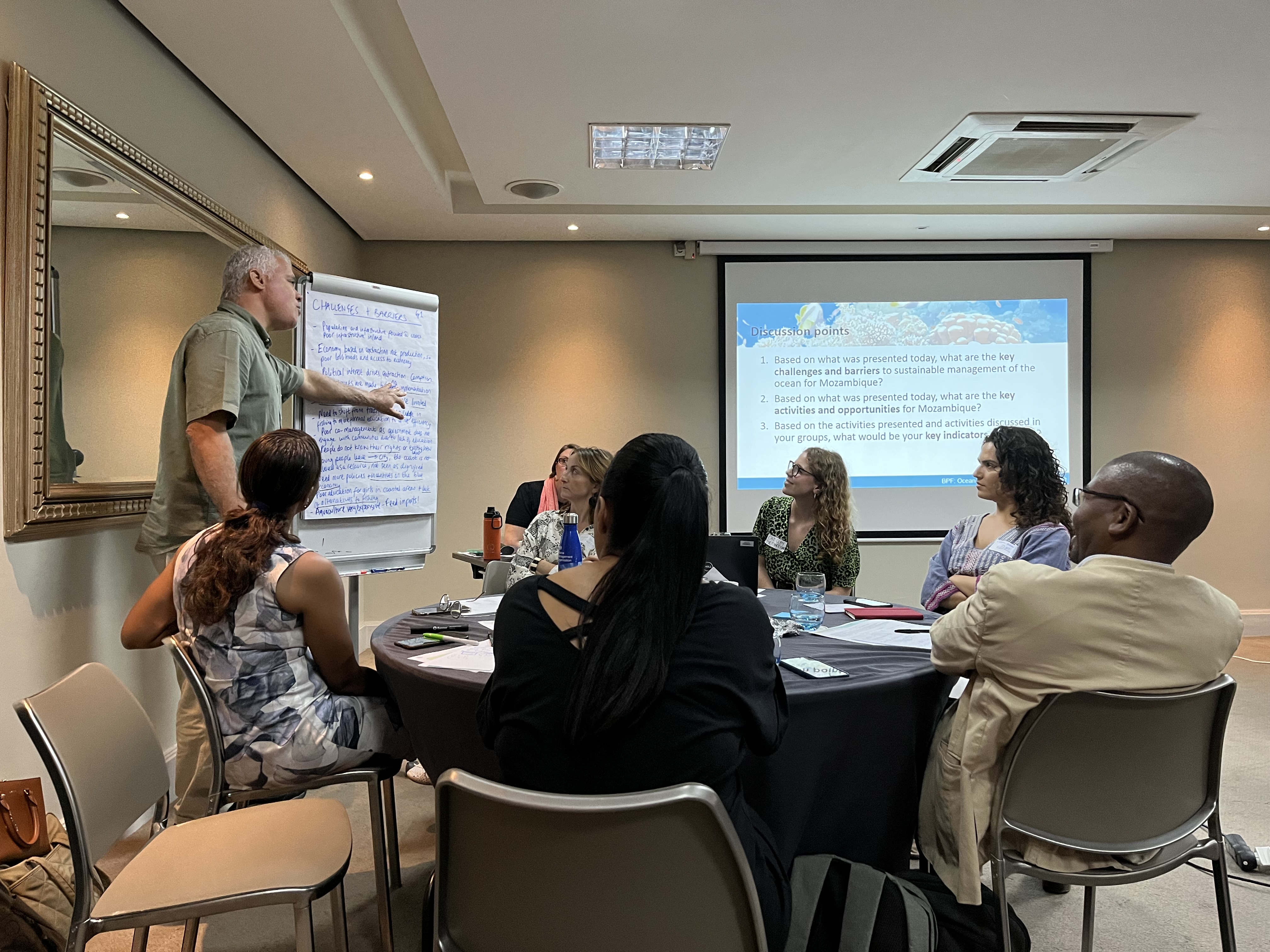 Image of breakout group at table during workshop in Mozambique