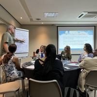 Image of breakout group at table during workshop in Mozambique