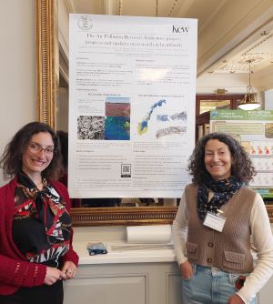 two people standing either side of a poster