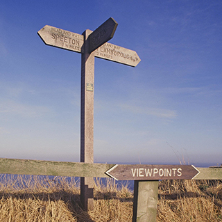 Photograph of a Countryside Commission signpost at Flamborough Head, showing grassland and the sea  (copyright Natural England/Peter Wakely).